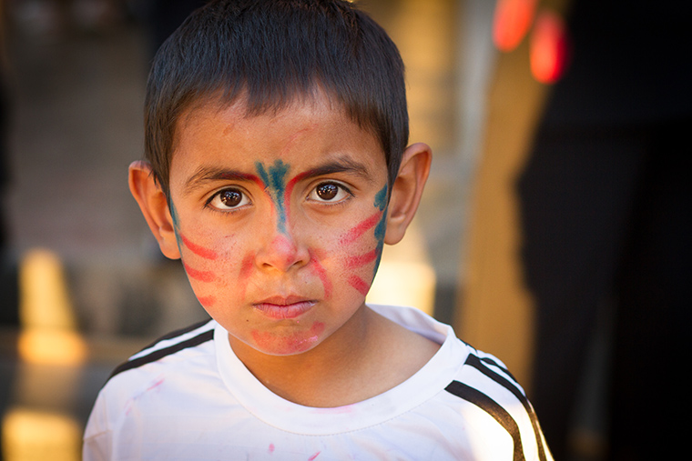 A young boy's face paint in nearly gone, after an energetic Easter party hosted by the local Assyrian church.