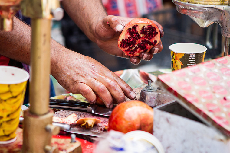 Pomegranates being prepared for juice, on Baghdad's Mutanabbi Street.