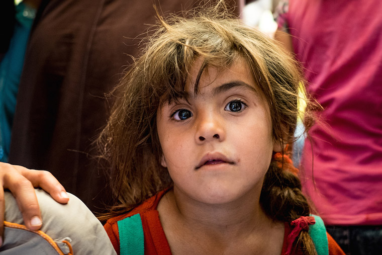 A young, displaced girl seen at the medical clinic. Families received emergency relief aid, water tanks, and medical care.