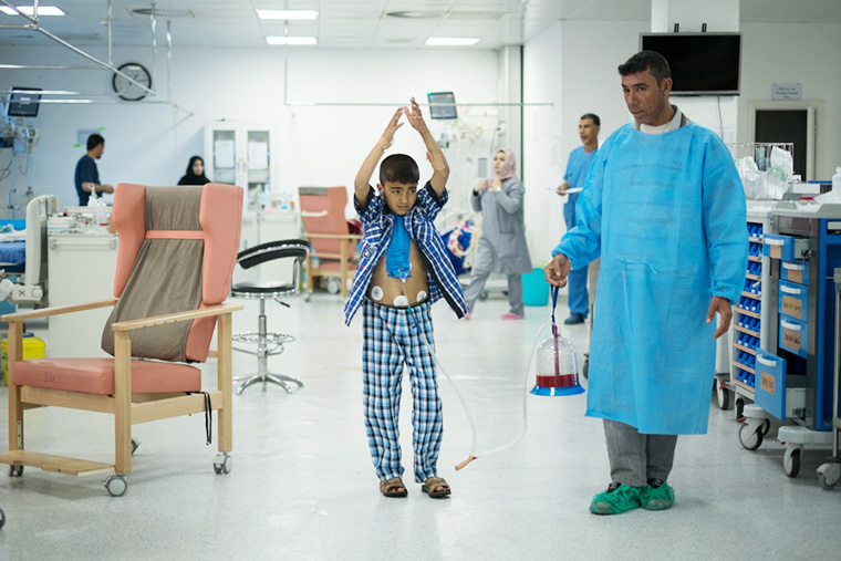 Young Mohammad walks the ICU with his father in Nasiriyah, Iraq after receiving the 1000th heart surgery through Preemptive Love Coalition.