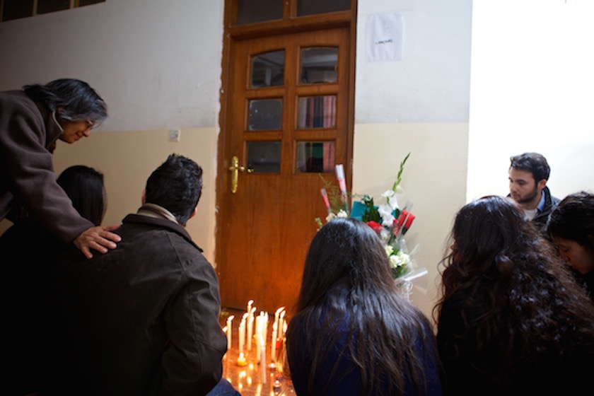 A photo of students gathered at Jeremiah Small's classroom to light candles and lay flowers.