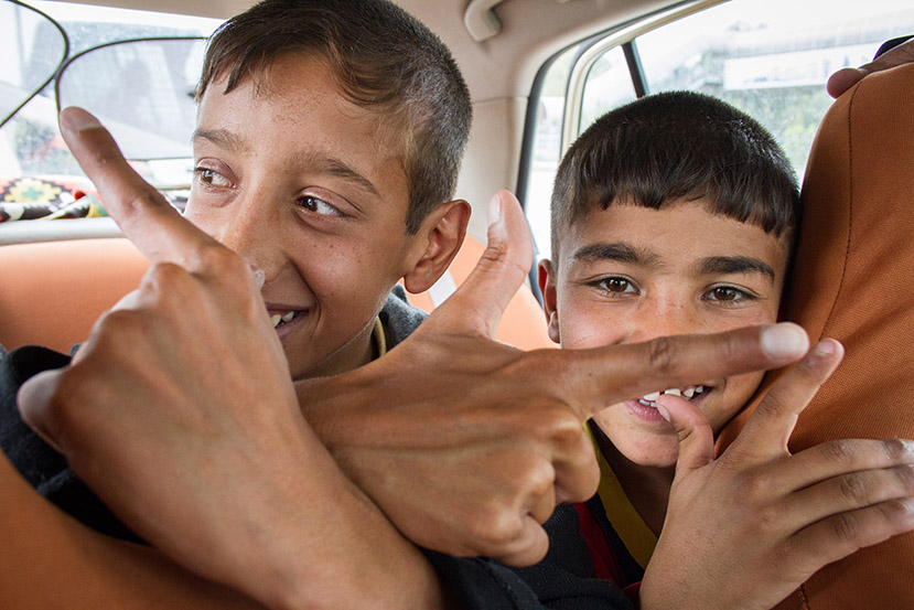 Young Mohammad and his fellow heart patient Ali ride in taxi to the airport. 