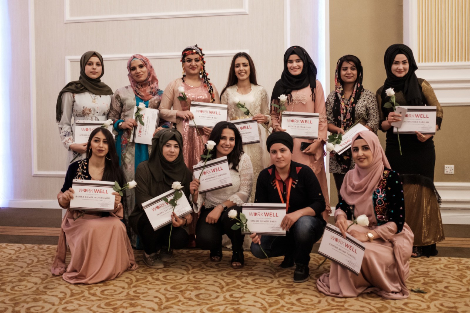 Women graduates from our Business IT program pose with their certificates.
